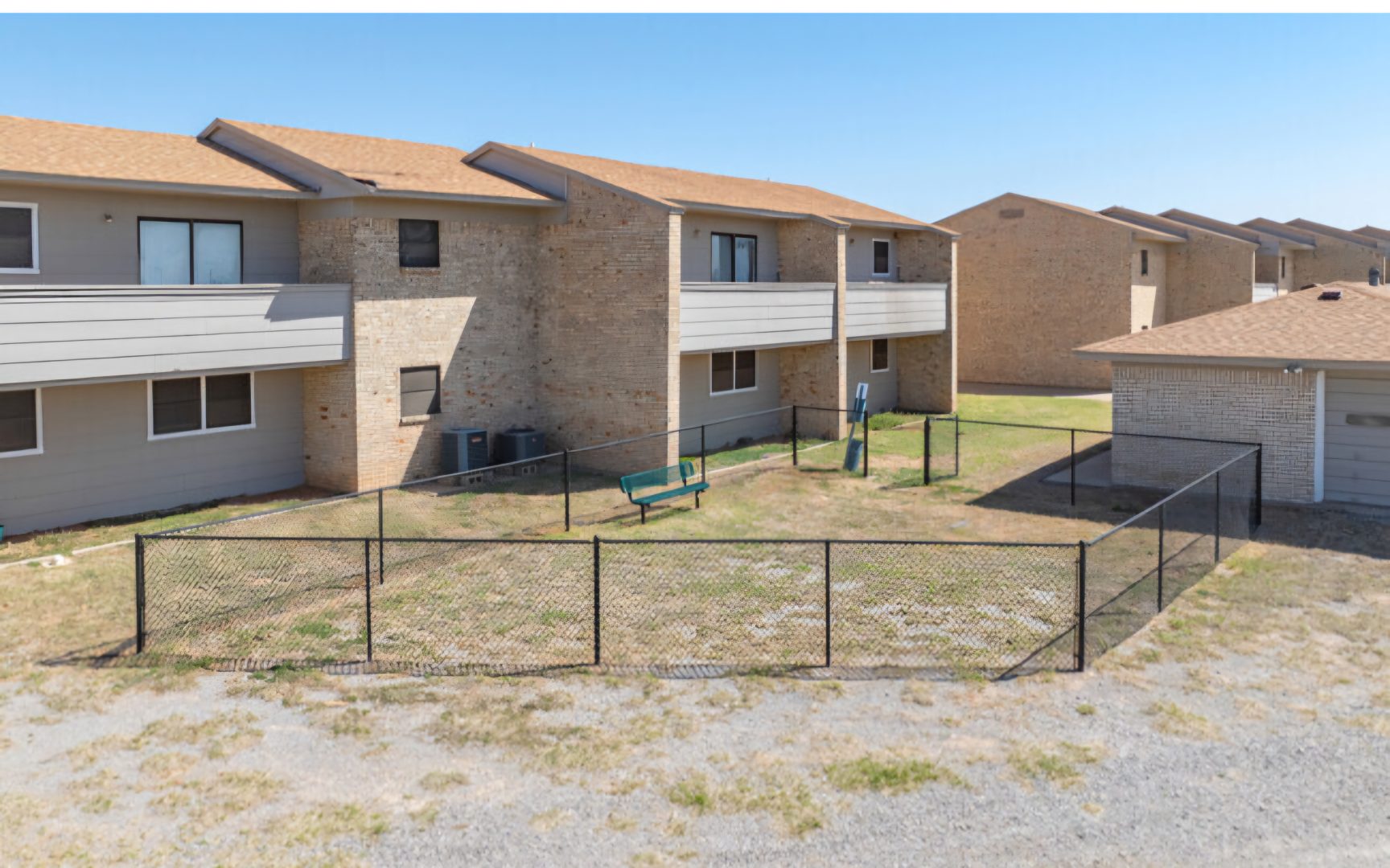 the apartment complex has a fenced in yard at The Courtyard