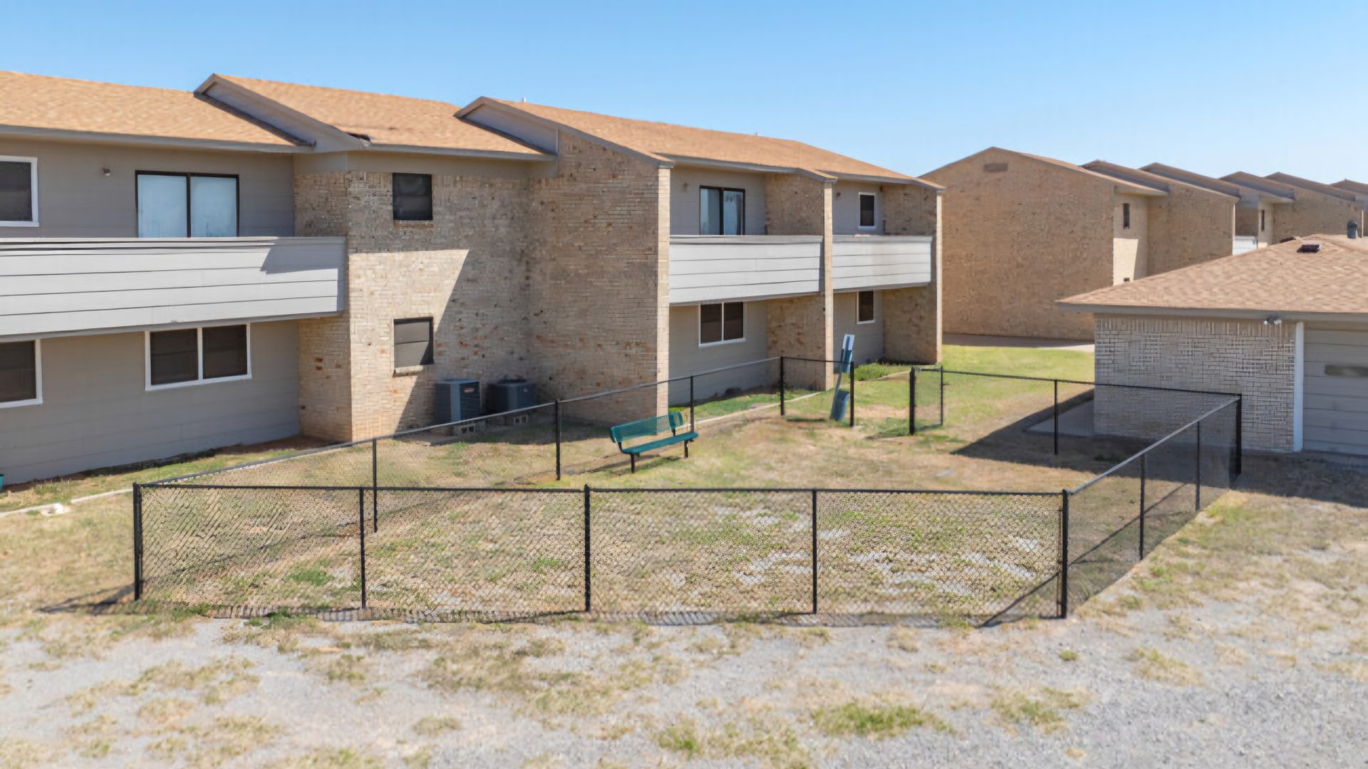 the apartment complex has a fenced in yard at The  Courtyard